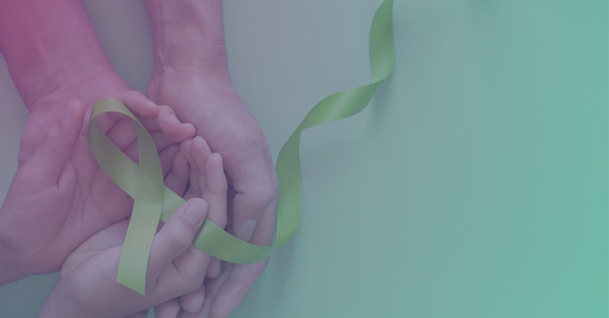 hands holding a green ribbon for mental health awareness day